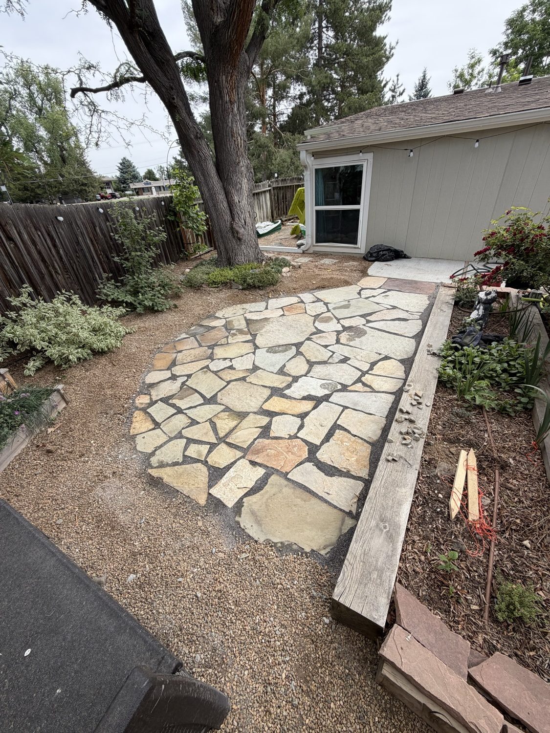 Paver driveway with landscape lighting at dusk by CJ Landscaping